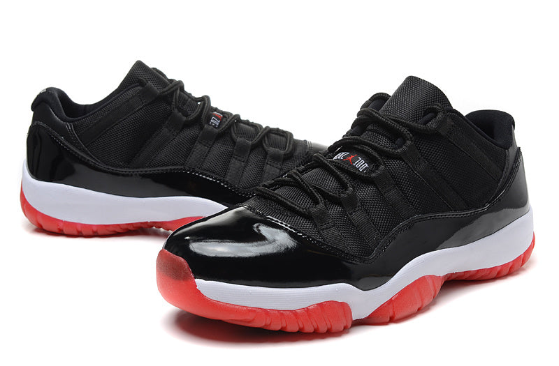 Air Jordan 11 Retro Low Black and Red Sneakers - product image from the listing.