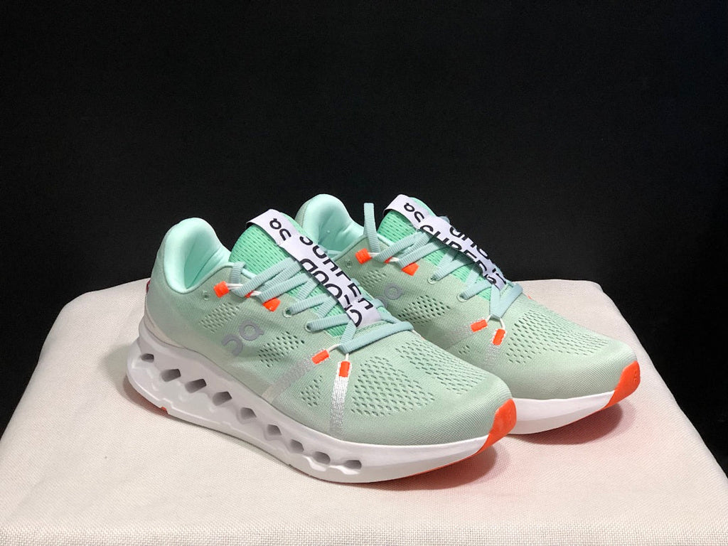 Pale Green and White On Cloudsurfer Sneakers - product image from the listing.