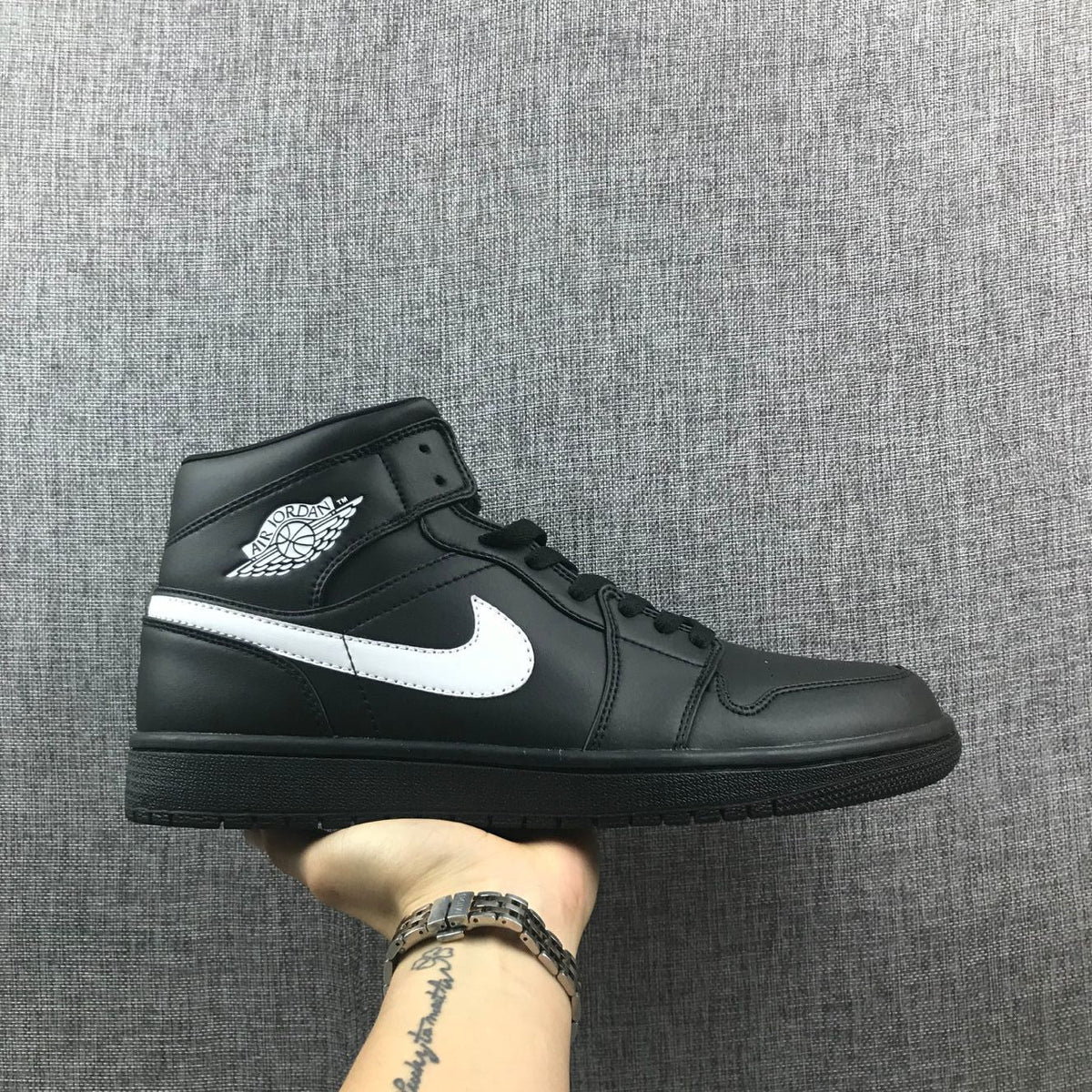 Air Jordan 1 Mid Sneakers in Black White 554724-049 - product image from the listing.