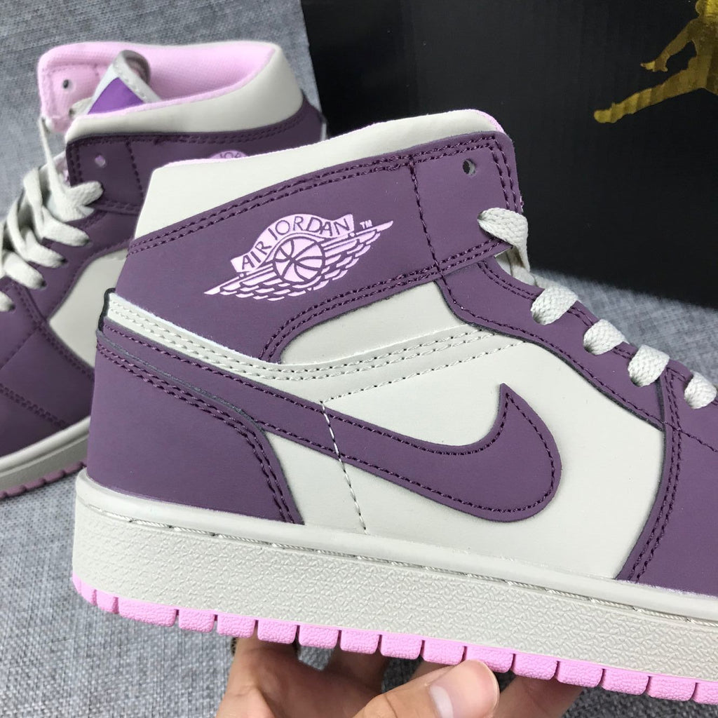Air Jordan 1 Mid Sneakers in Pink Purple 555112-500 - product image from the listing.