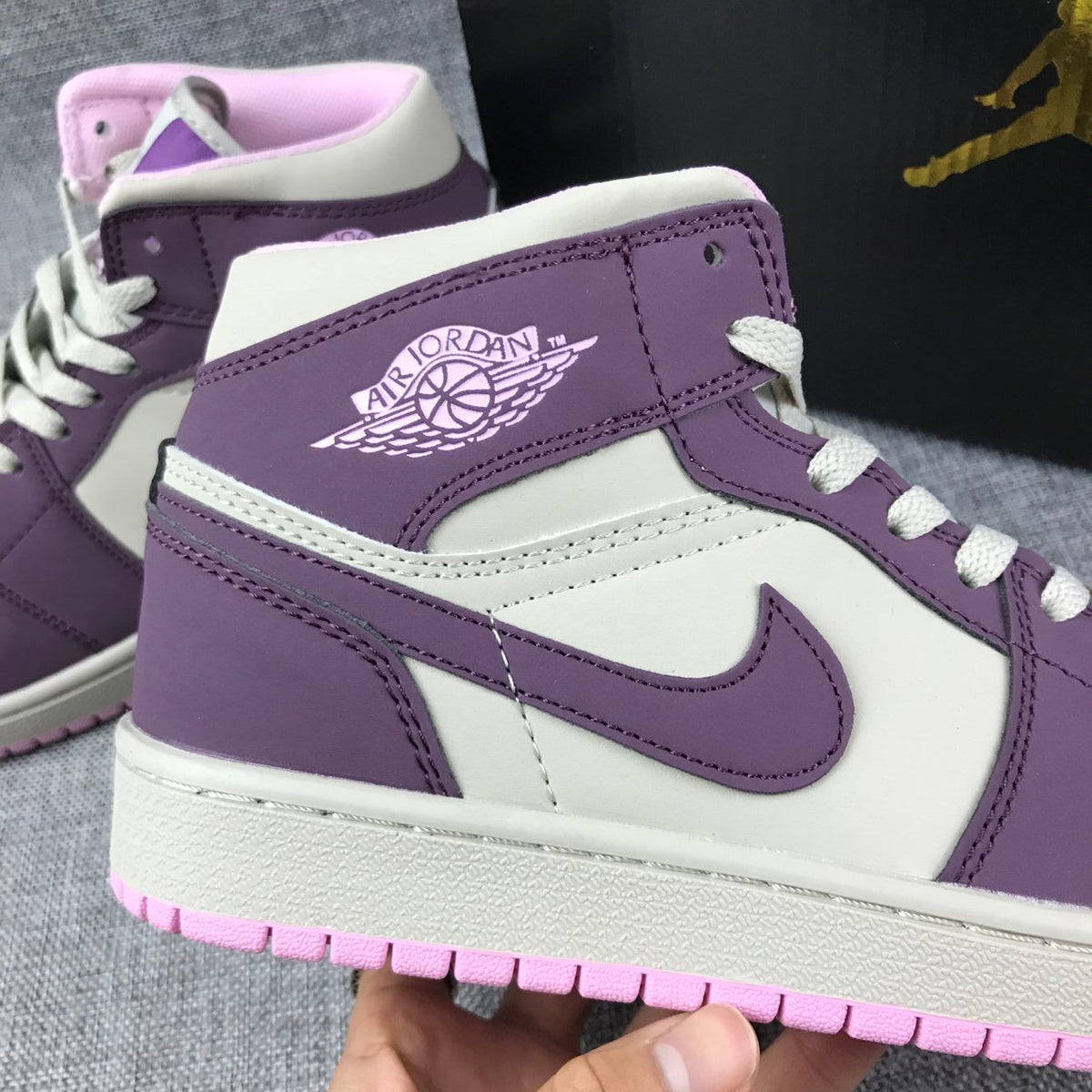 Air Jordan 1 Mid Sneakers in Pink Purple 555112-500 - product image from the listing.