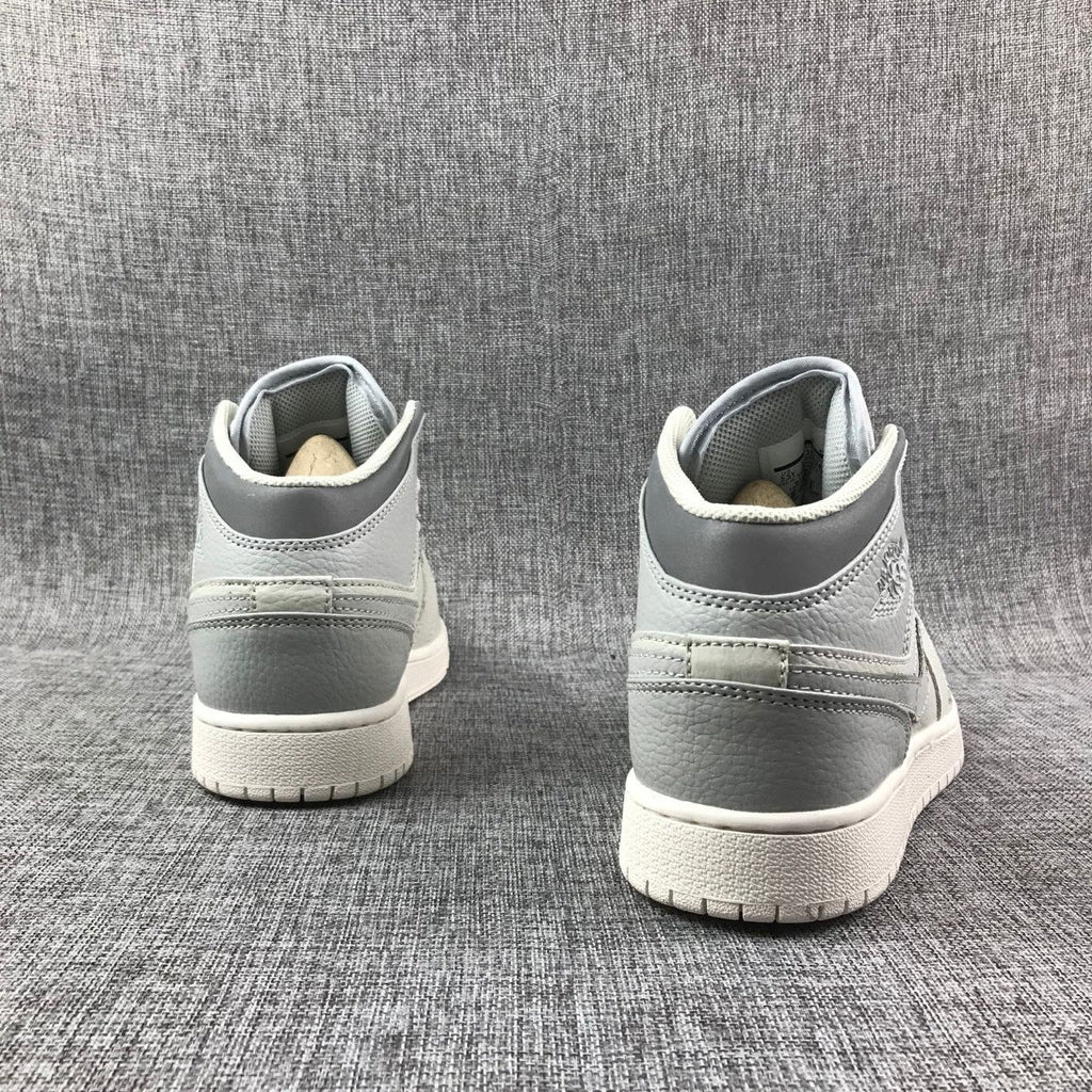 White and Grey Air Jordan 1 Mid Sneakers - product image from the listing.
