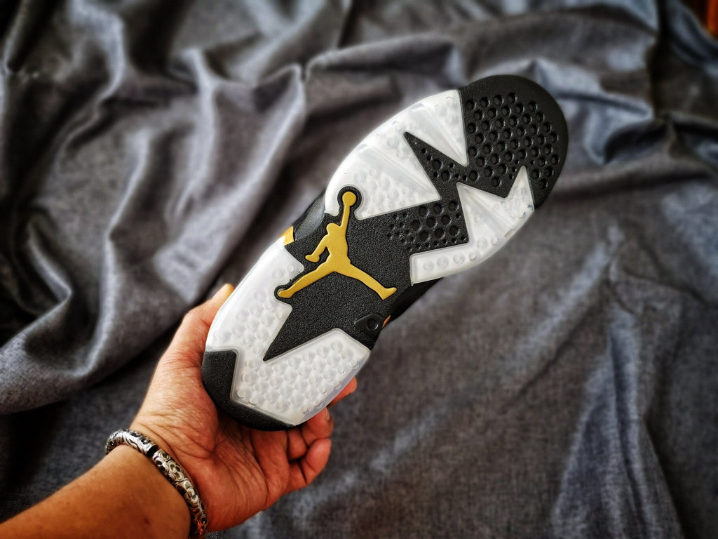 Air Jordan 6 High-Top Sneakers in Black and Gold - product image from the listing.