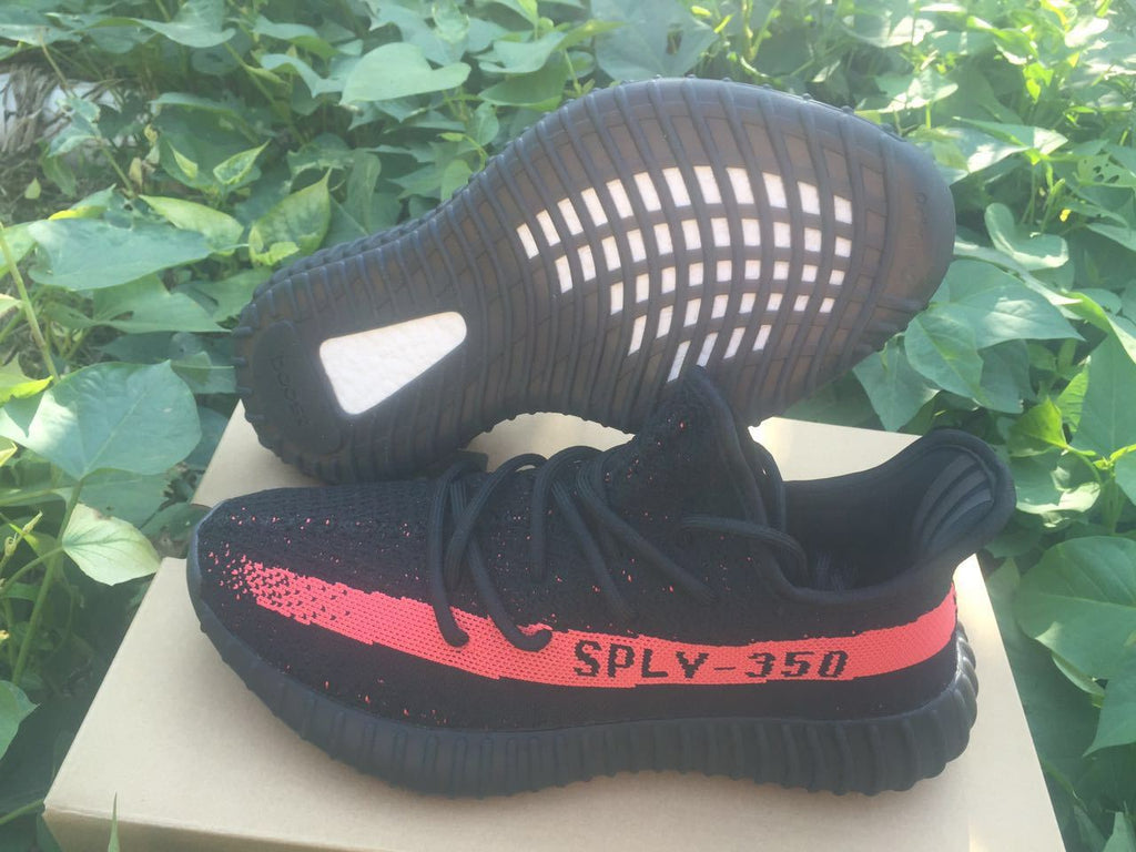 Yeezy Boost 350 V2 Sneakers in Black and Bright Coral - product image from the listing.
