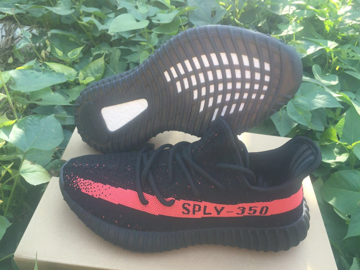 Yeezy Boost 350 V2 Sneakers in Black and Bright Coral - product image from the listing.
