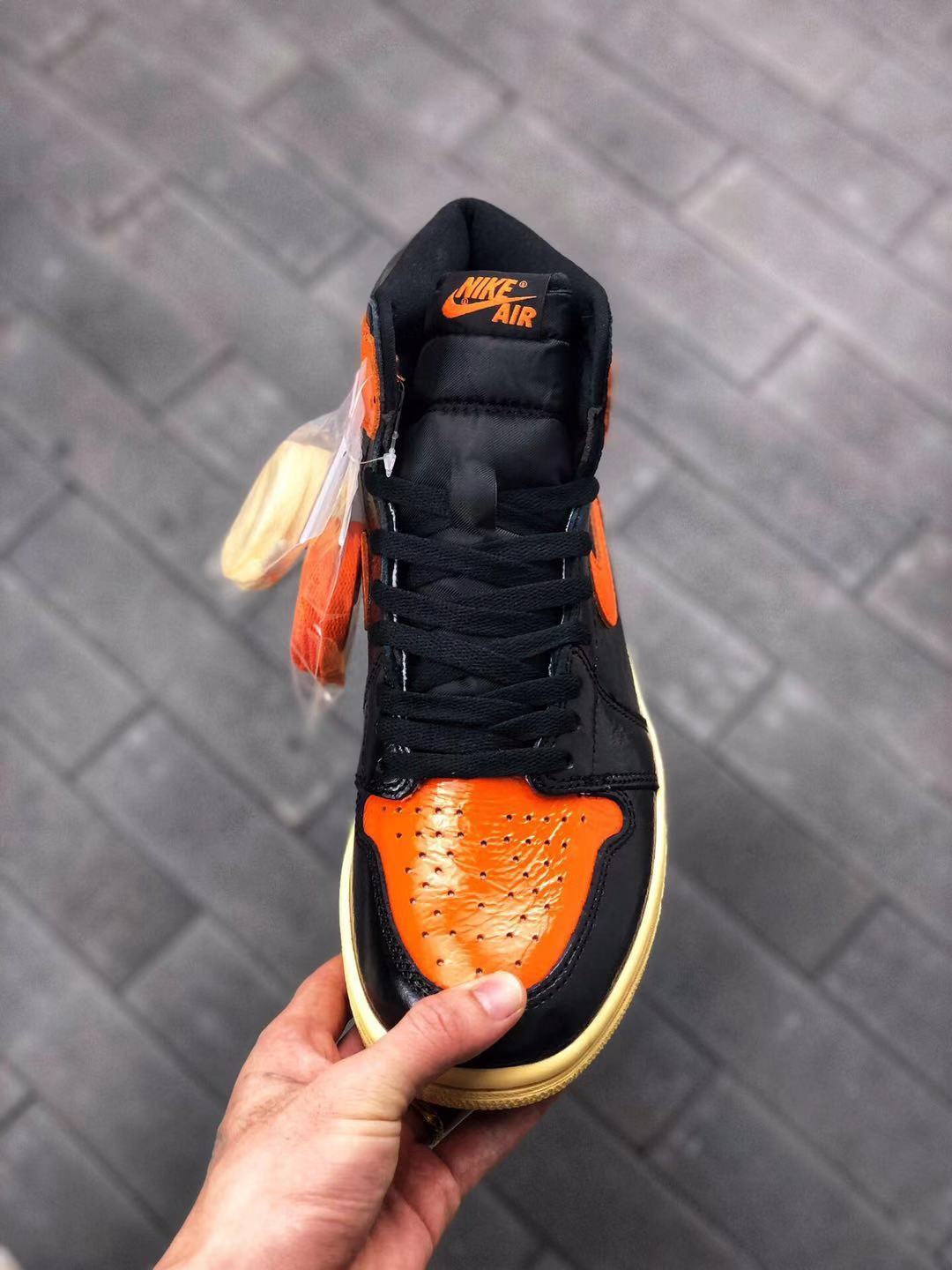 Air Jordan 1 Retro High OG Sneakers in Black and Orange - product image from the listing.