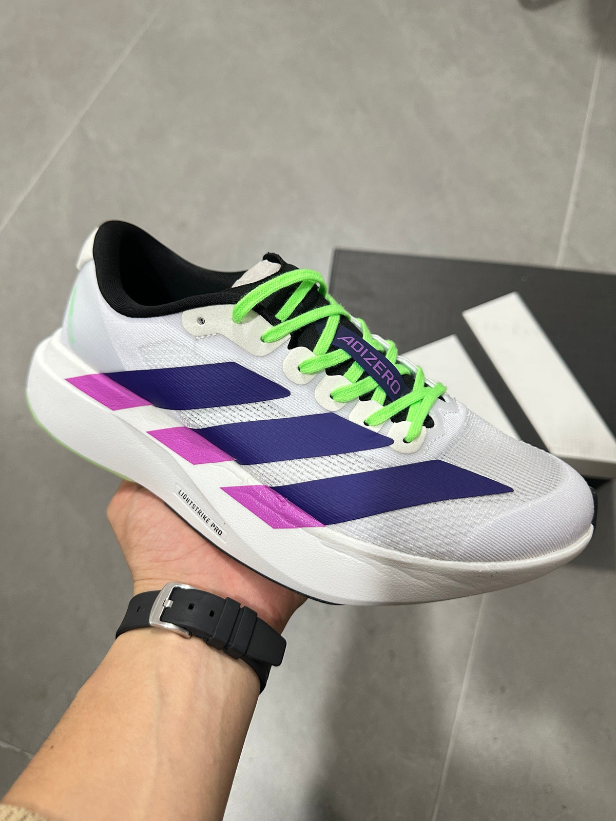 Adizero Lightstrike Pro Running Shoes in White Purple Green - product image from the listing.