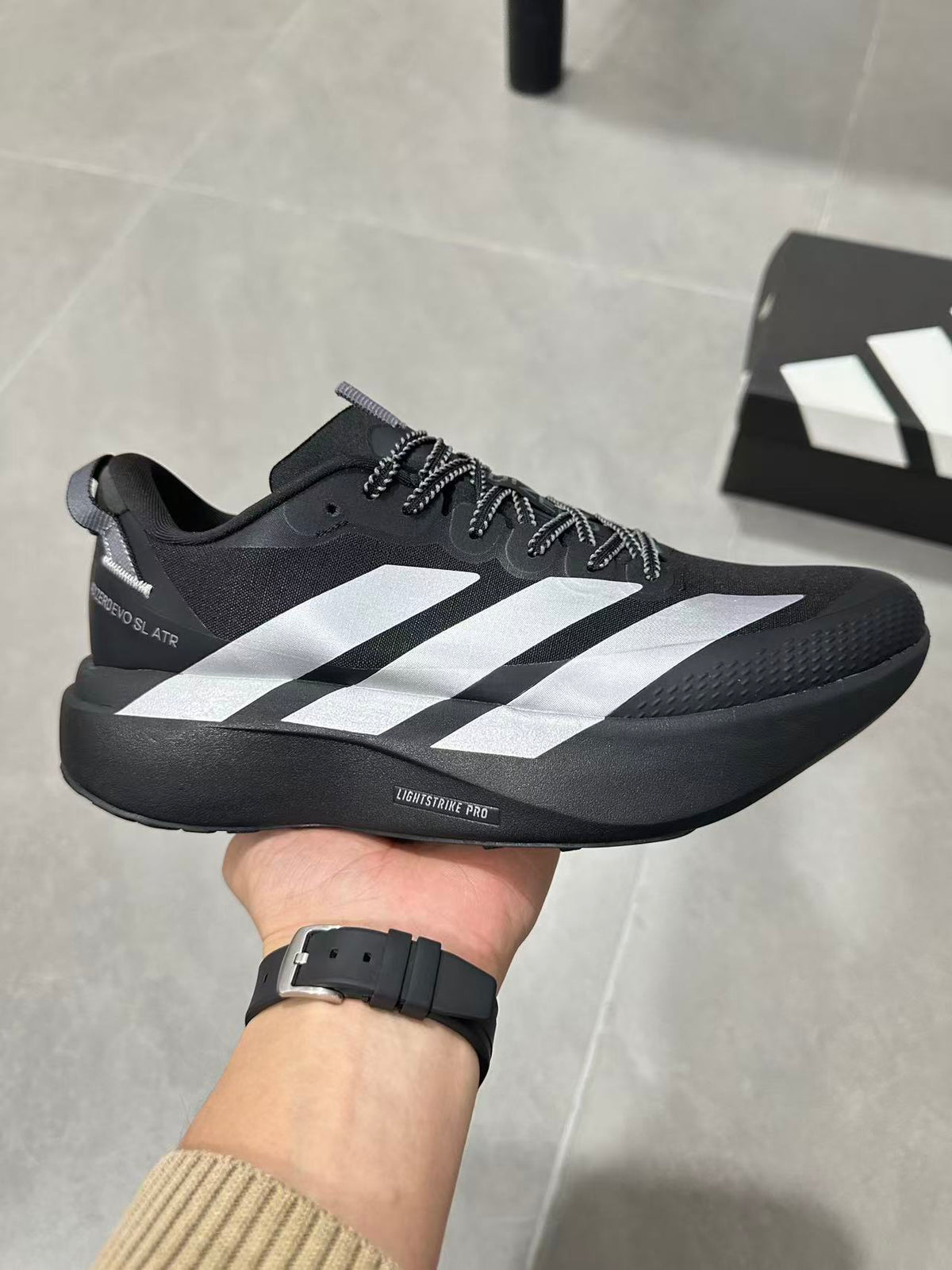Adidas Lightstrike Pro Black Shoes for Running with White Stripes - product image from the listing.