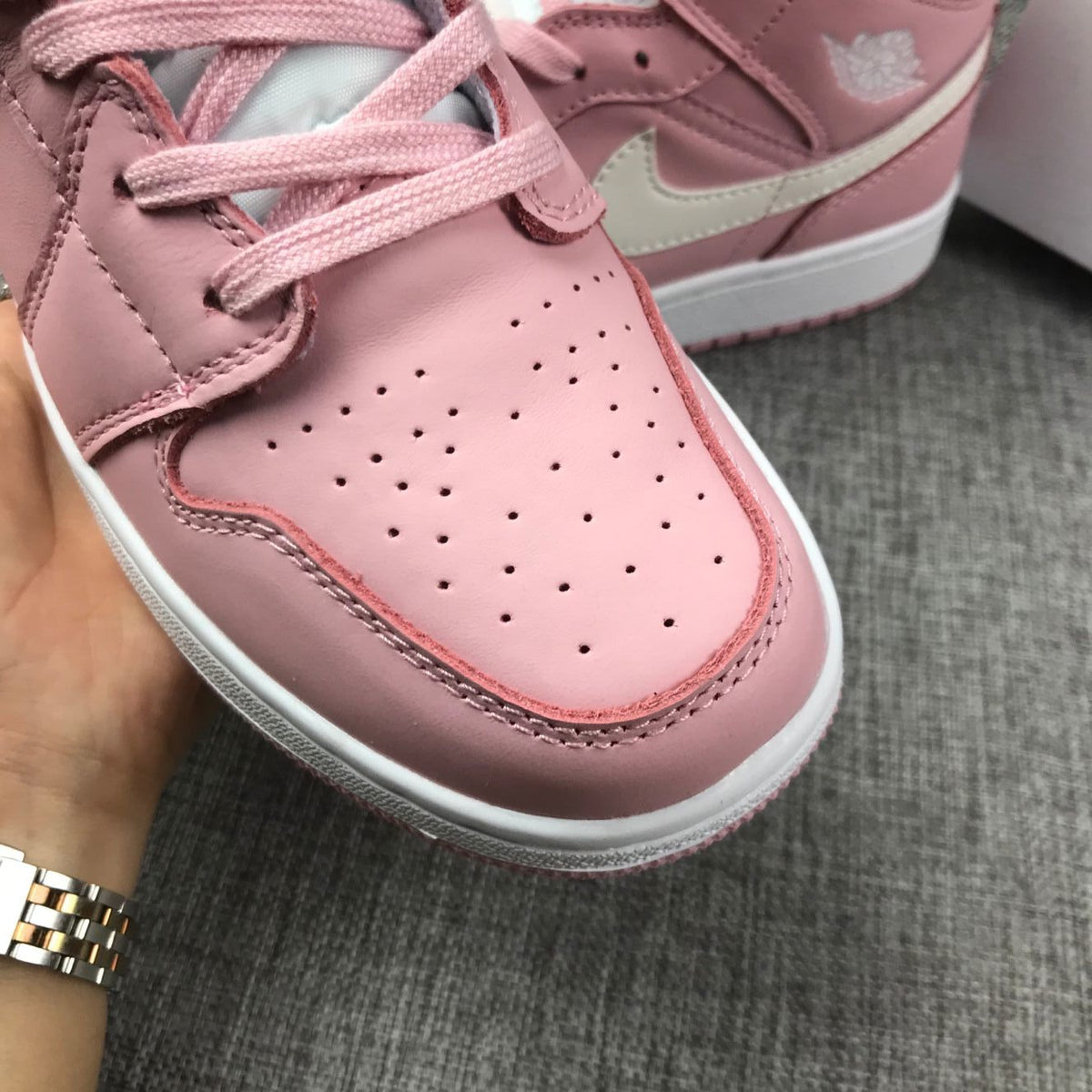 Women's Jordan 1 Mid Pink Sneakers 555112-100 - product image from the listing.