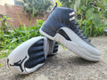 Air Jordan 12 Retro in Black/Light Grey - product image from the listing.