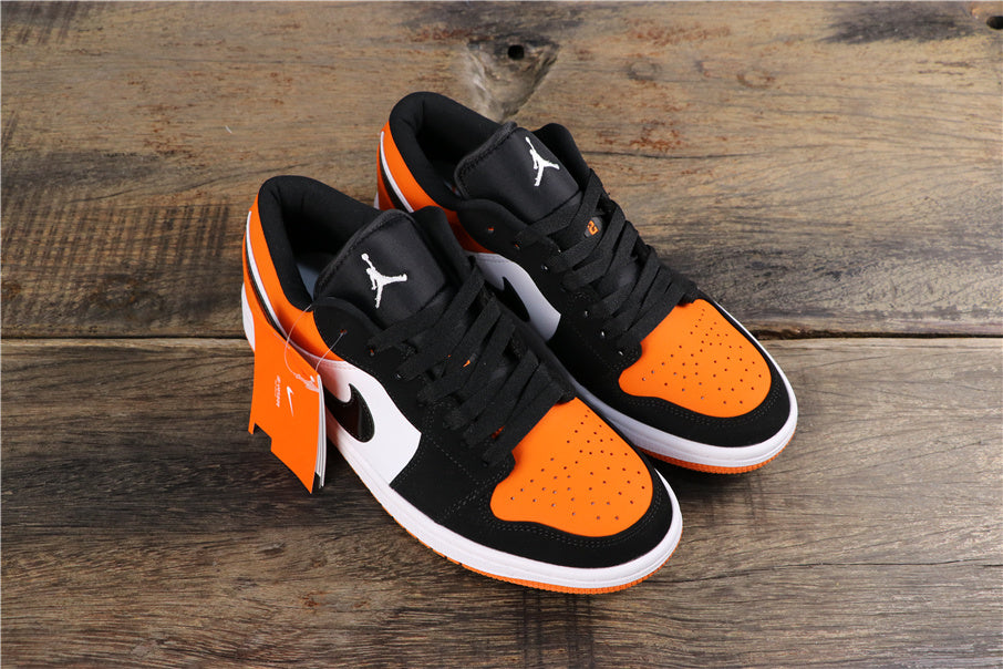 Air Jordan 1 Low Black White Orange Sneakers 553558-128 - product image from the listing.