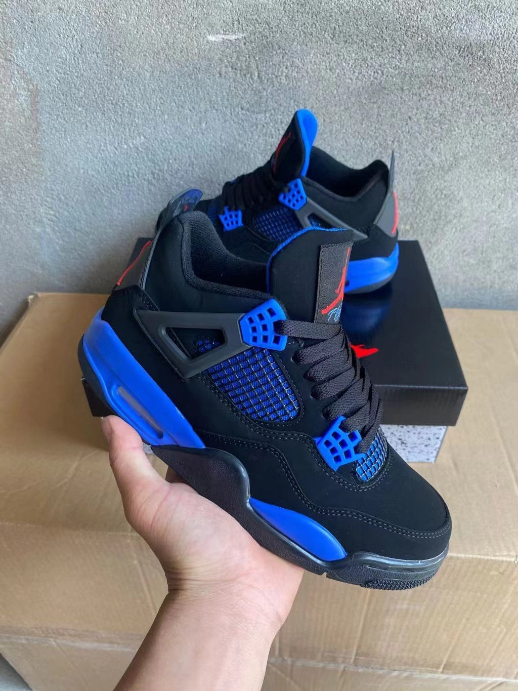 Air Jordan 4 Sneakers in Blue and Red - product image from the listing.