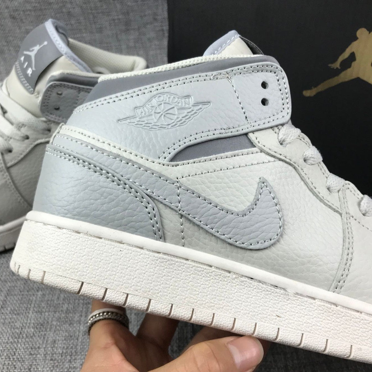White and Grey Air Jordan 1 Mid Sneakers - product image from the listing.