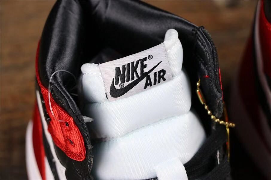 Air Jordan 1 Satin Black Toe High-Cut Sneakers - product image from the listing.