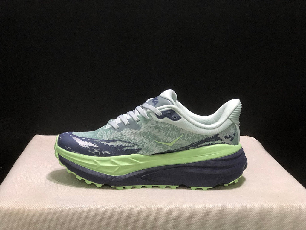 HOKA Stinson 7 Trail Running Shoes, in Green and Navy - product image from the listing.