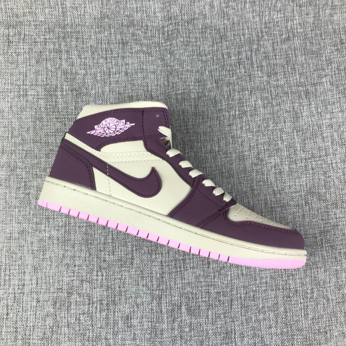Air Jordan 1 Mid Sneakers in Pink Purple 555112-500 - product image from the listing.