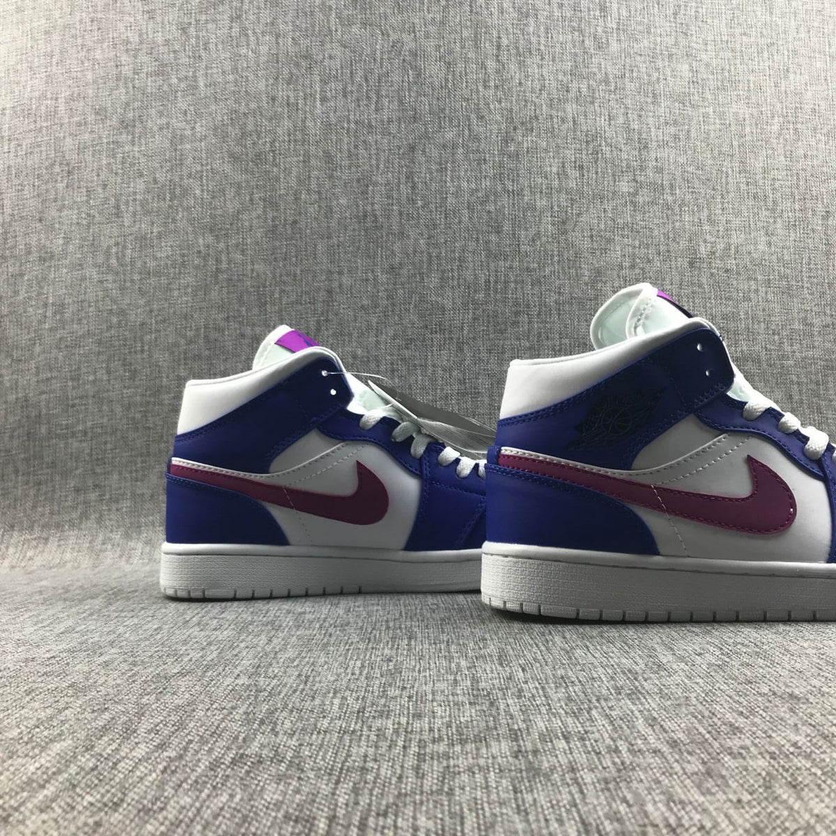 Air Jordan 1 Mid Sneakers in Blue Pink 554724-451 - product image from the listing.