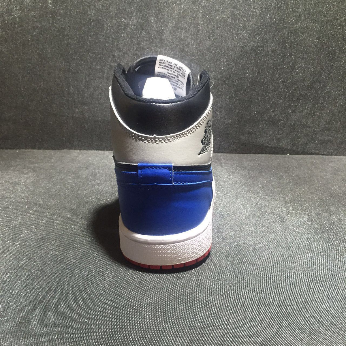 Jordan 1 High Three-Color Sneaker in Black, in Blue and Red - product image from the listing.