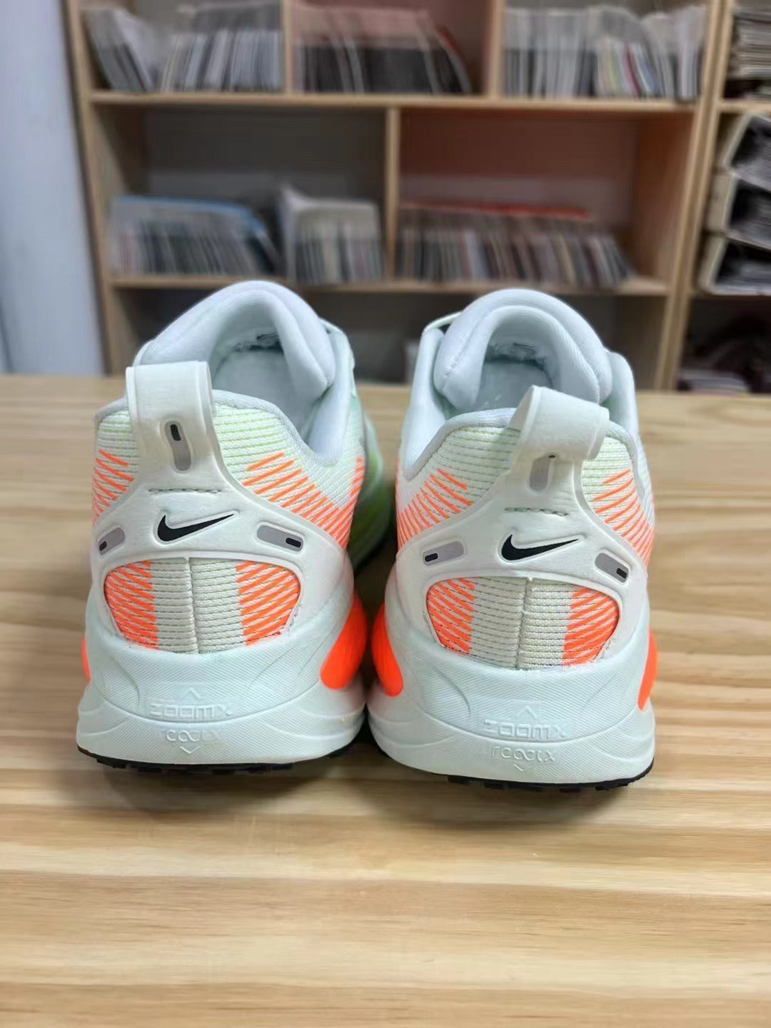 Nike Vomero 18 Running Shoes in Light Blue and Volt - product image from the listing.