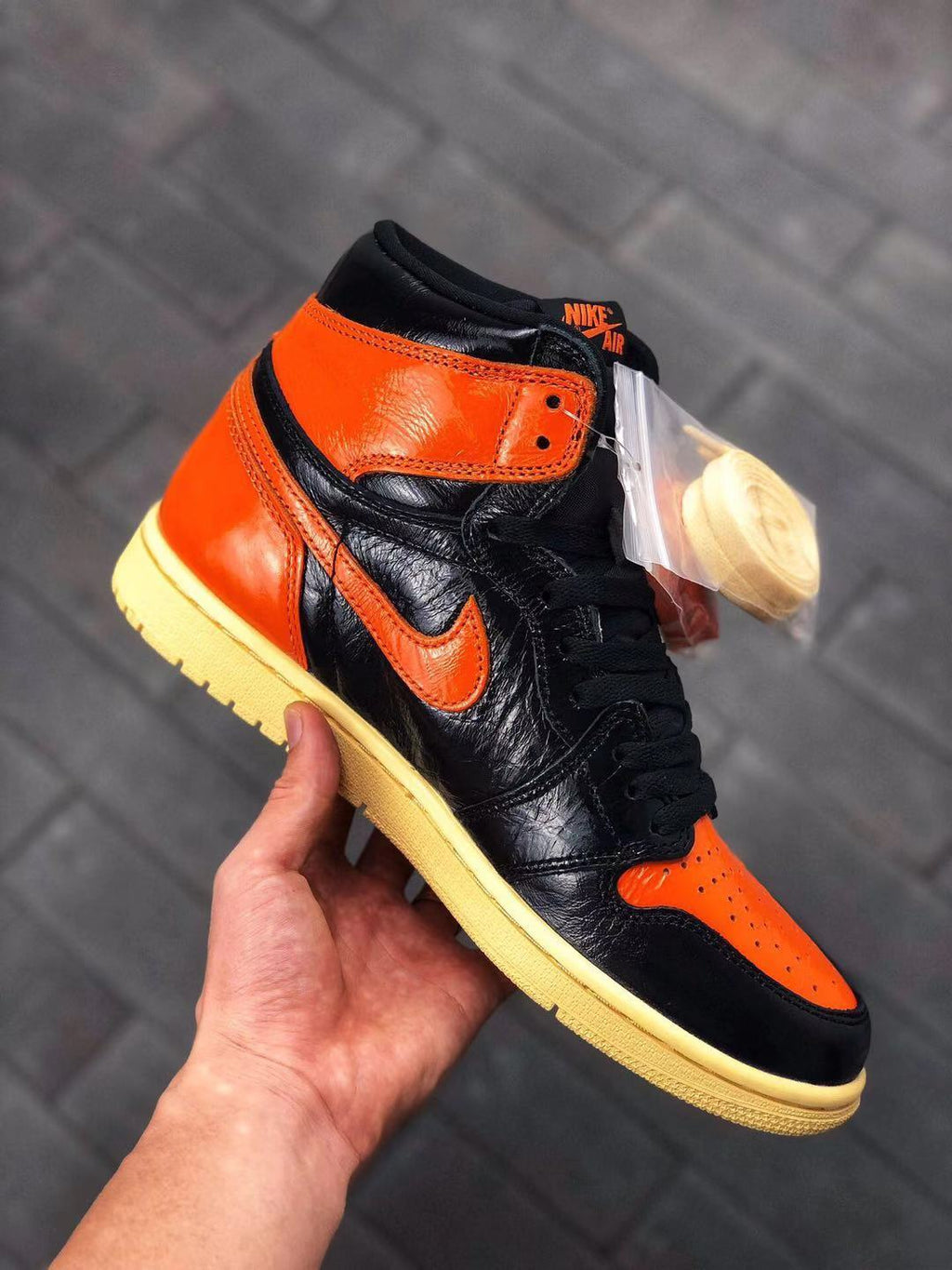 Air Jordan 1 Retro High OG Sneakers in Black and Orange - product image from the listing.