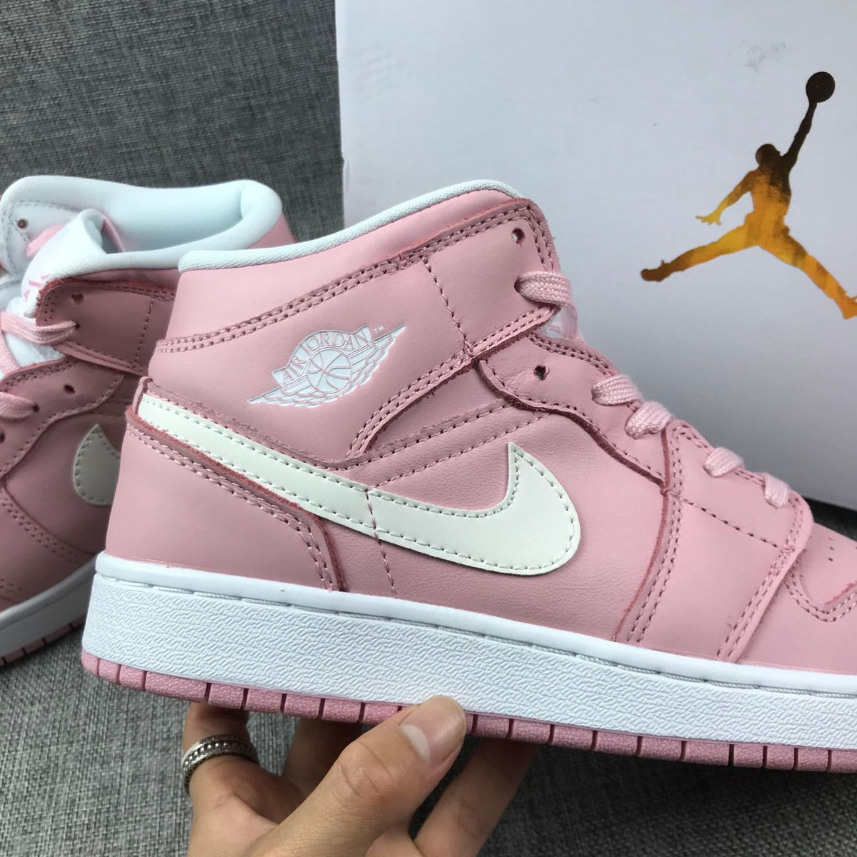 Women's Jordan 1 Mid Pink Sneakers 555112-100 - product image from the listing.
