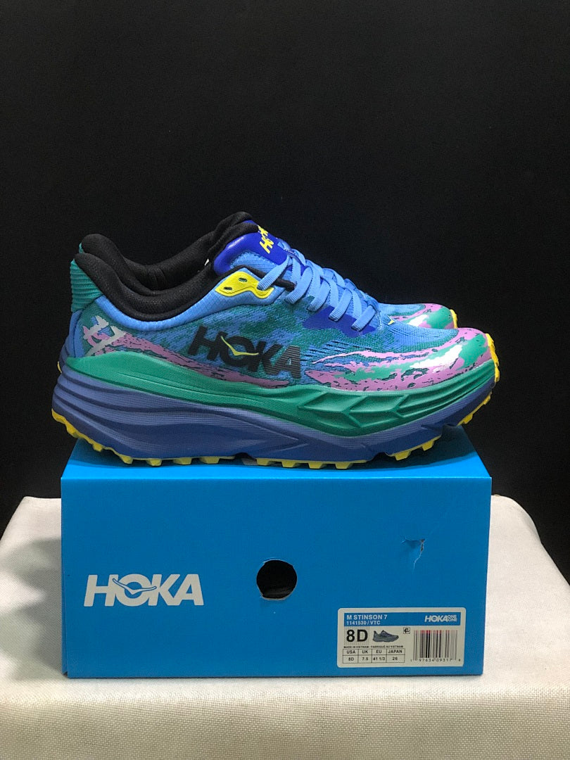 HOKA Stinson 7 Trail Sneakers in Blue Green Pink Yellow - product image from the listing.