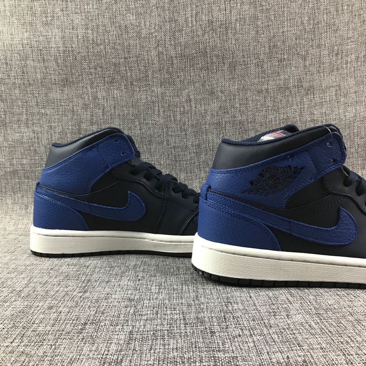 Air Jordan 1 Mid High-Top Sneakers in Black and Royal Blue - product image from the listing.