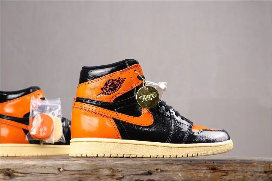 Air Jordan 1 Retro High OG Sneakers in Black and Orange - product image from the listing.