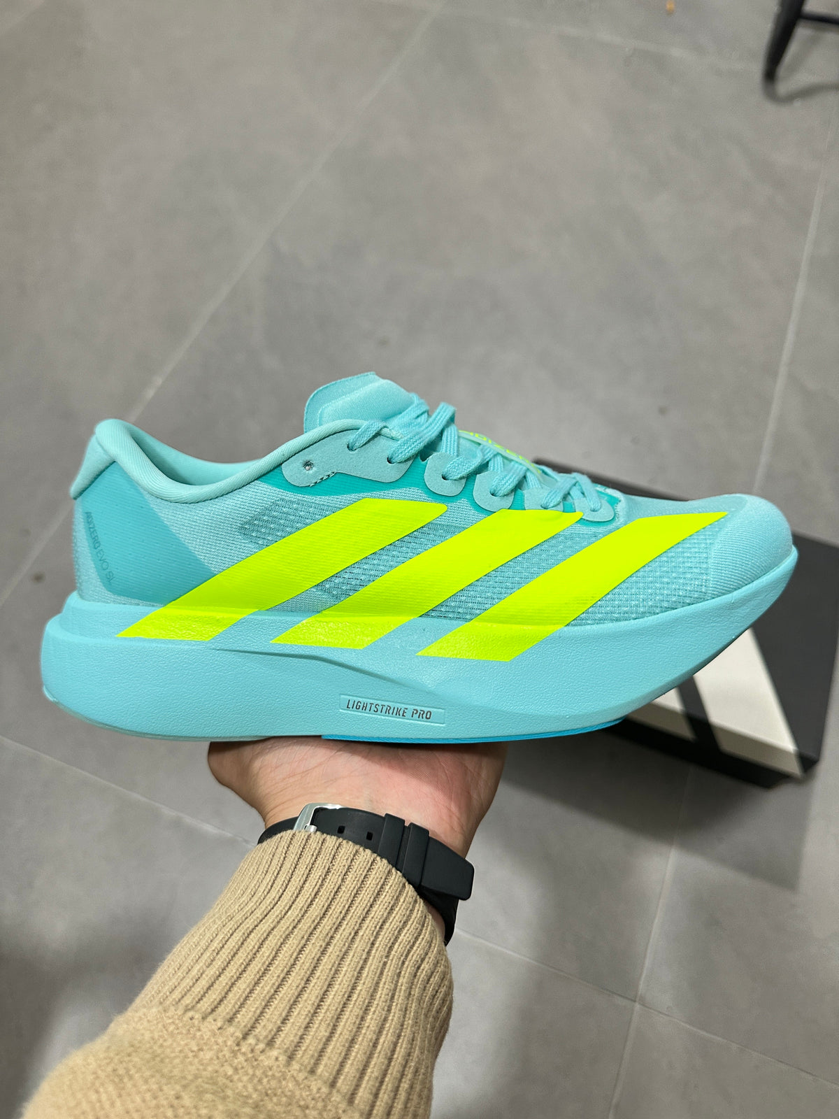 Adidas Lightstrike Pro Running Shoes, in Turquoise and Volt - product image from the listing.