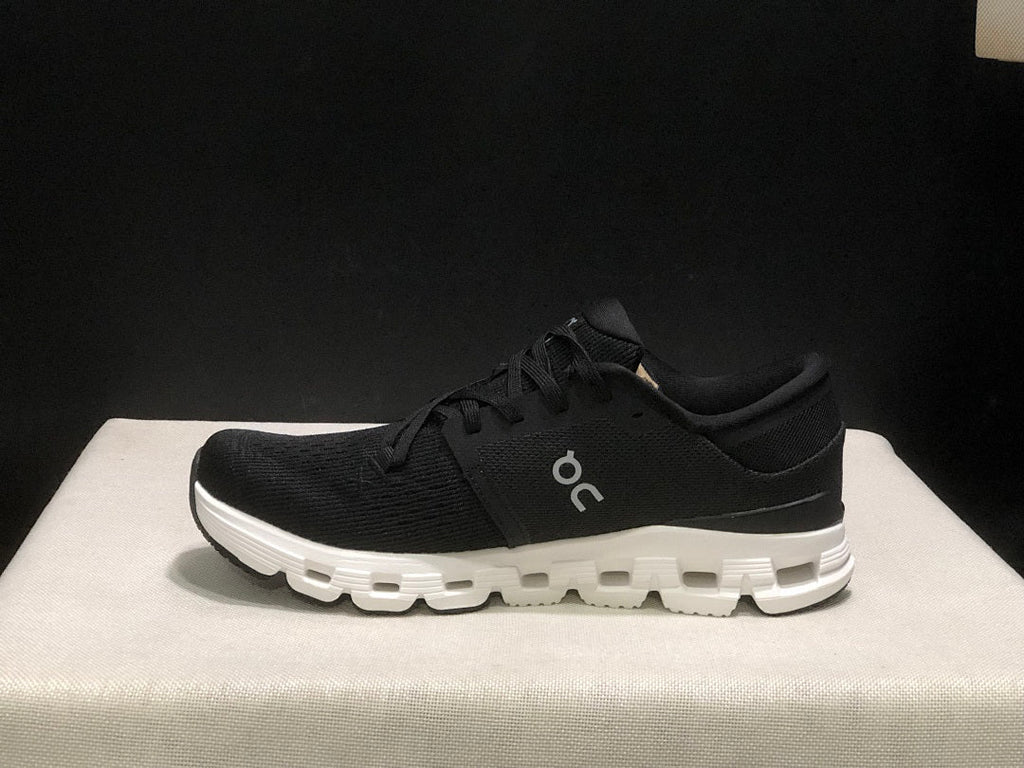 On Cloud X 4 Sneakers in Black and White - product image from the listing.