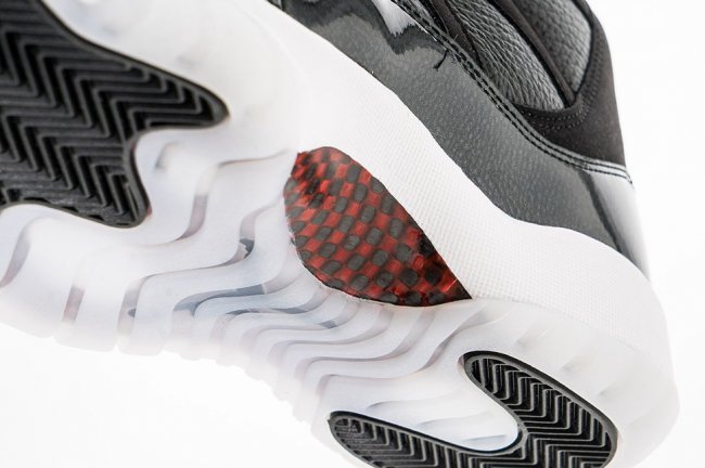 Air Jordan 11 Retro 72-10 High-Top Sneakers in Black and White - product image from the listing.