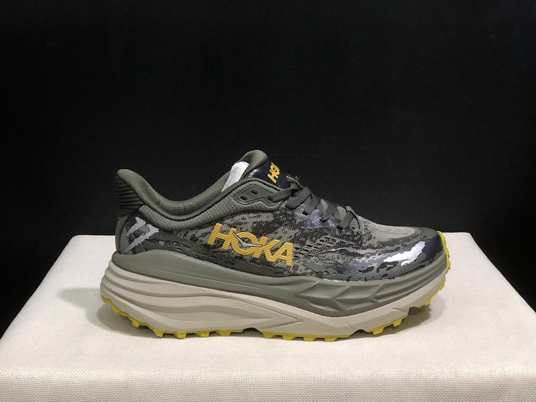 HOKA Stinson 7 Trail Running Shoes, in Gray and Yellow - product image from the listing.