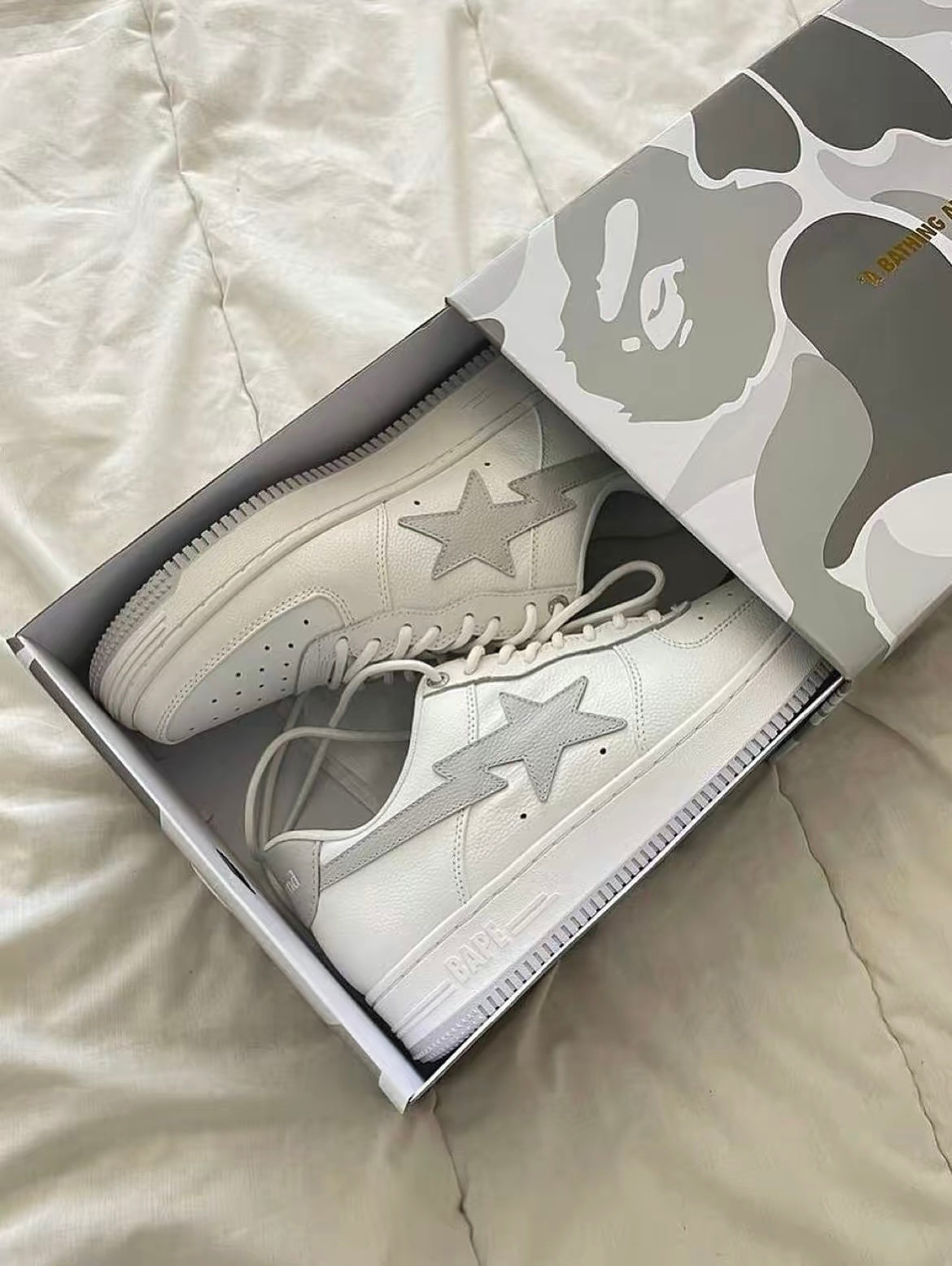 White and Grey BAPE STA Low Sneakers - product image from the listing.