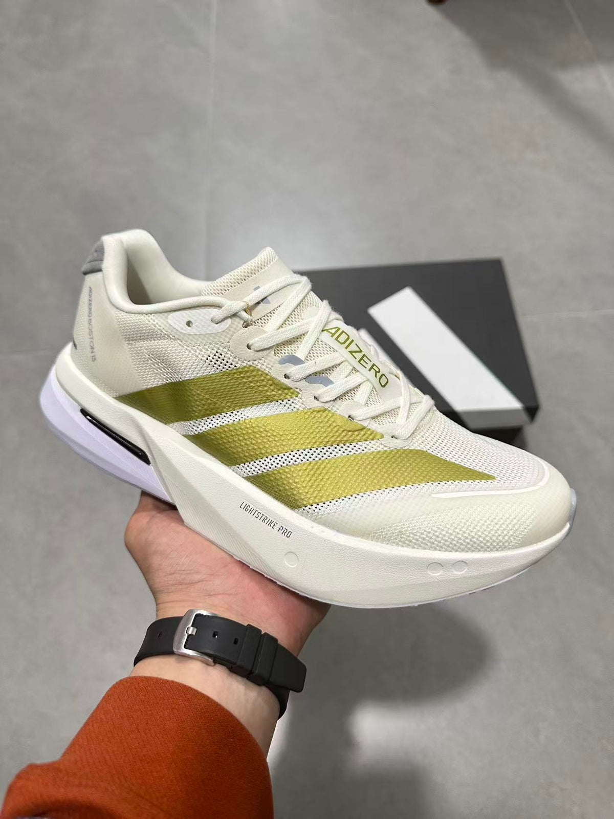 Adizero Lightstrike Pro Running Shoes in White and Olive JS4947 - product image from the listing.