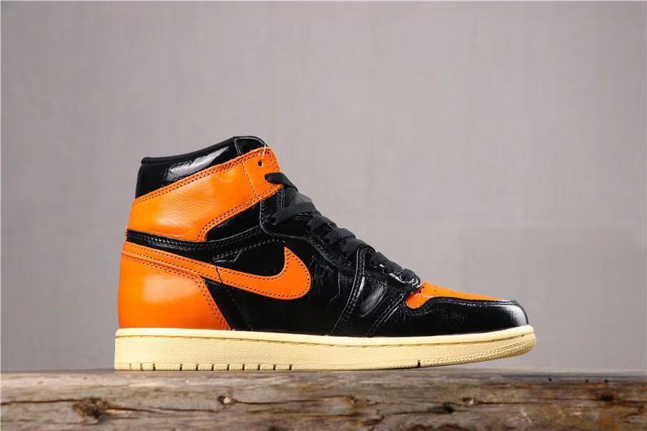 Air Jordan 1 Retro High OG Sneakers in Black and Orange - product image from the listing.