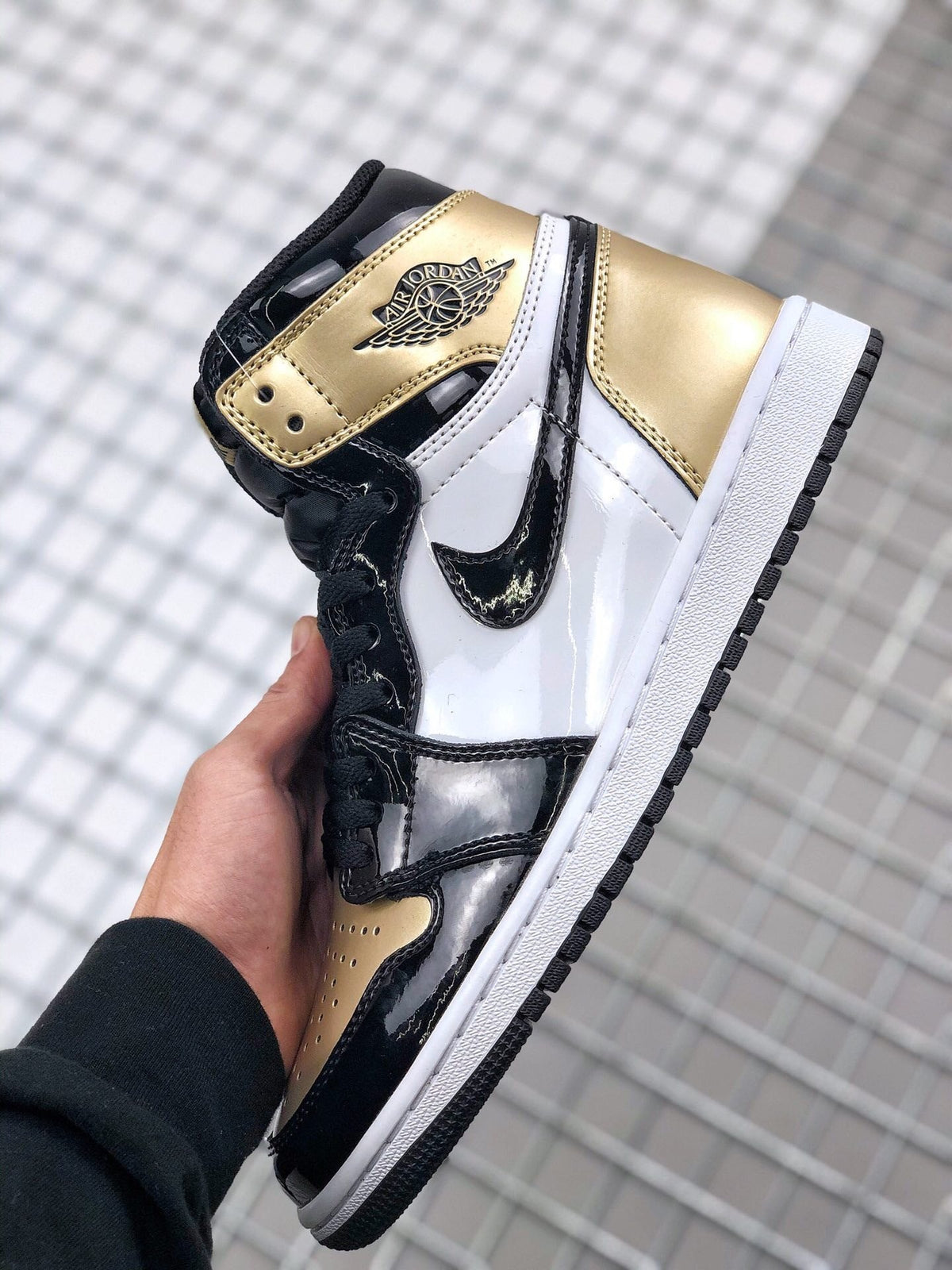 Air Jordan 1 High Gold Toe Sneakers in Black and Gold - product image from the listing.