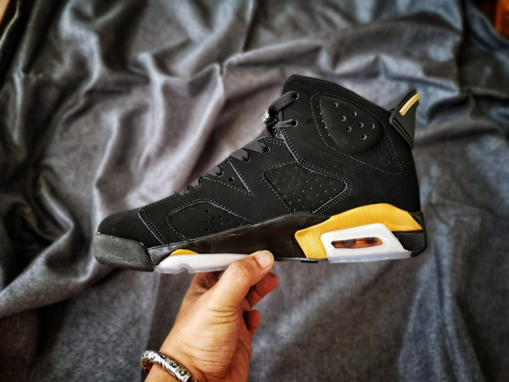 Air Jordan 6 High-Top Sneakers in Black and Gold - product image from the listing.