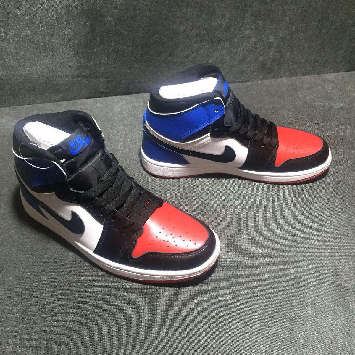 Jordan 1 High Three-Color Sneaker in Black, in Blue and Red - product image from the listing.