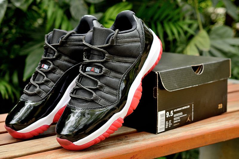 Air Jordan 11 Retro Low Black and Red Sneakers - product image from the listing.