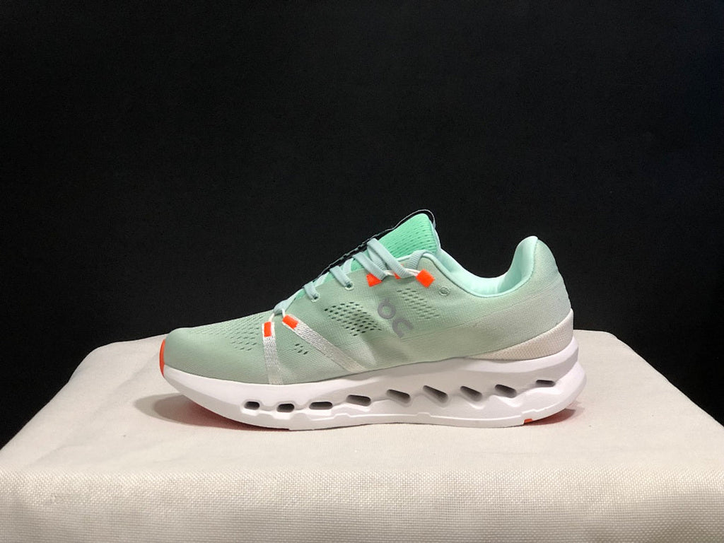 Pale Green and White On Cloudsurfer Sneakers - product image from the listing.
