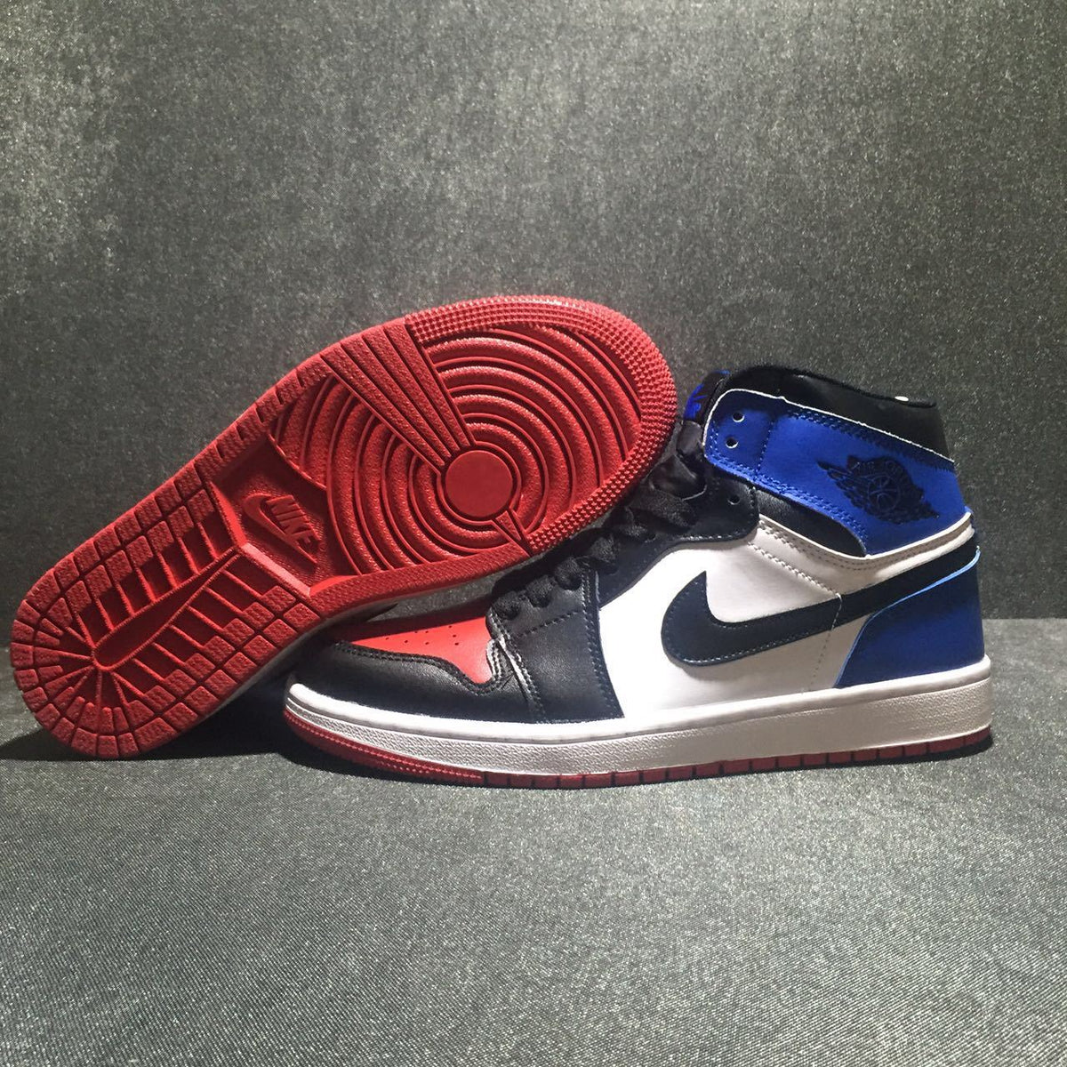 Jordan 1 High Three-Color Sneaker in Black, in Blue and Red - product image from the listing.
