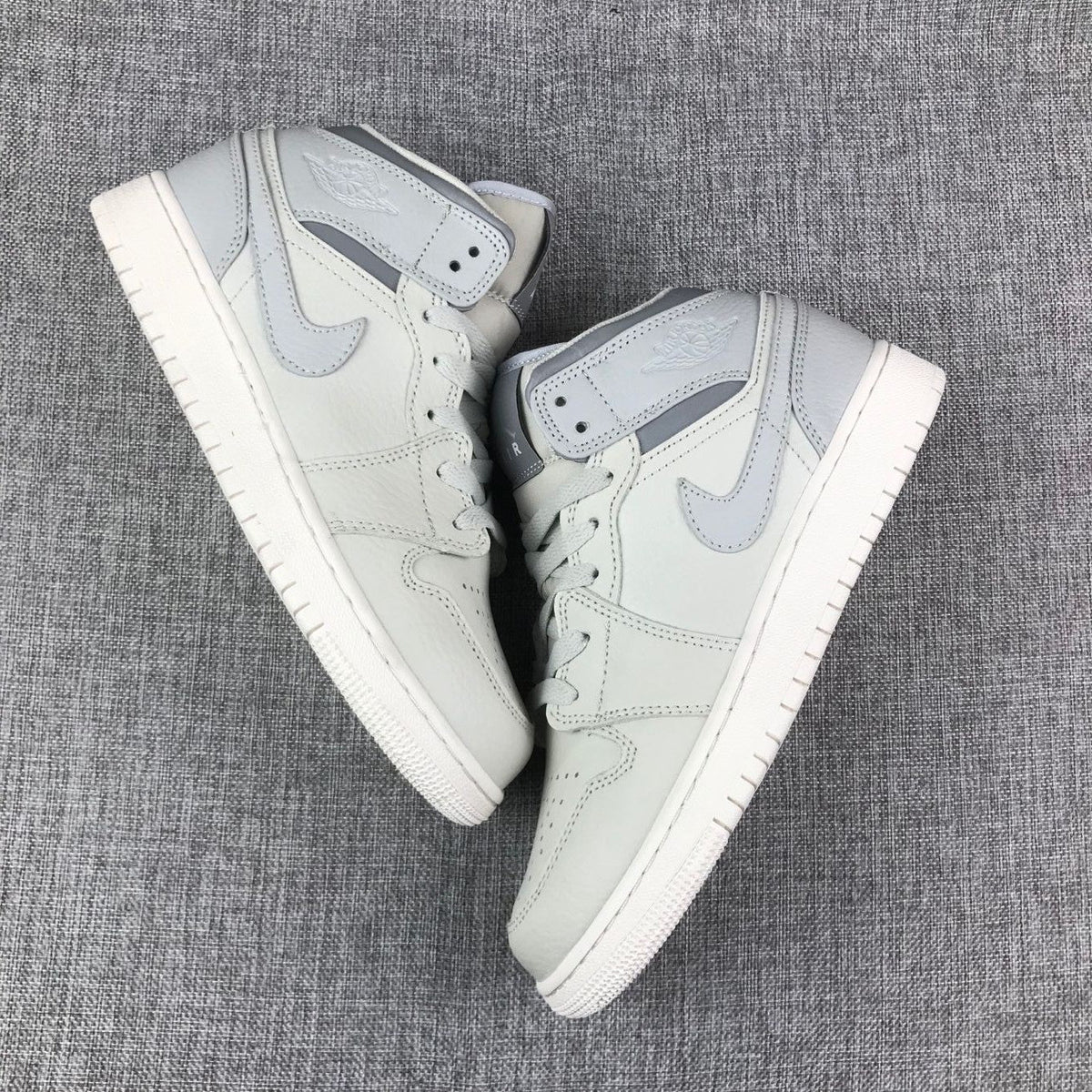 White and Grey Air Jordan 1 Mid Sneakers - product image from the listing.