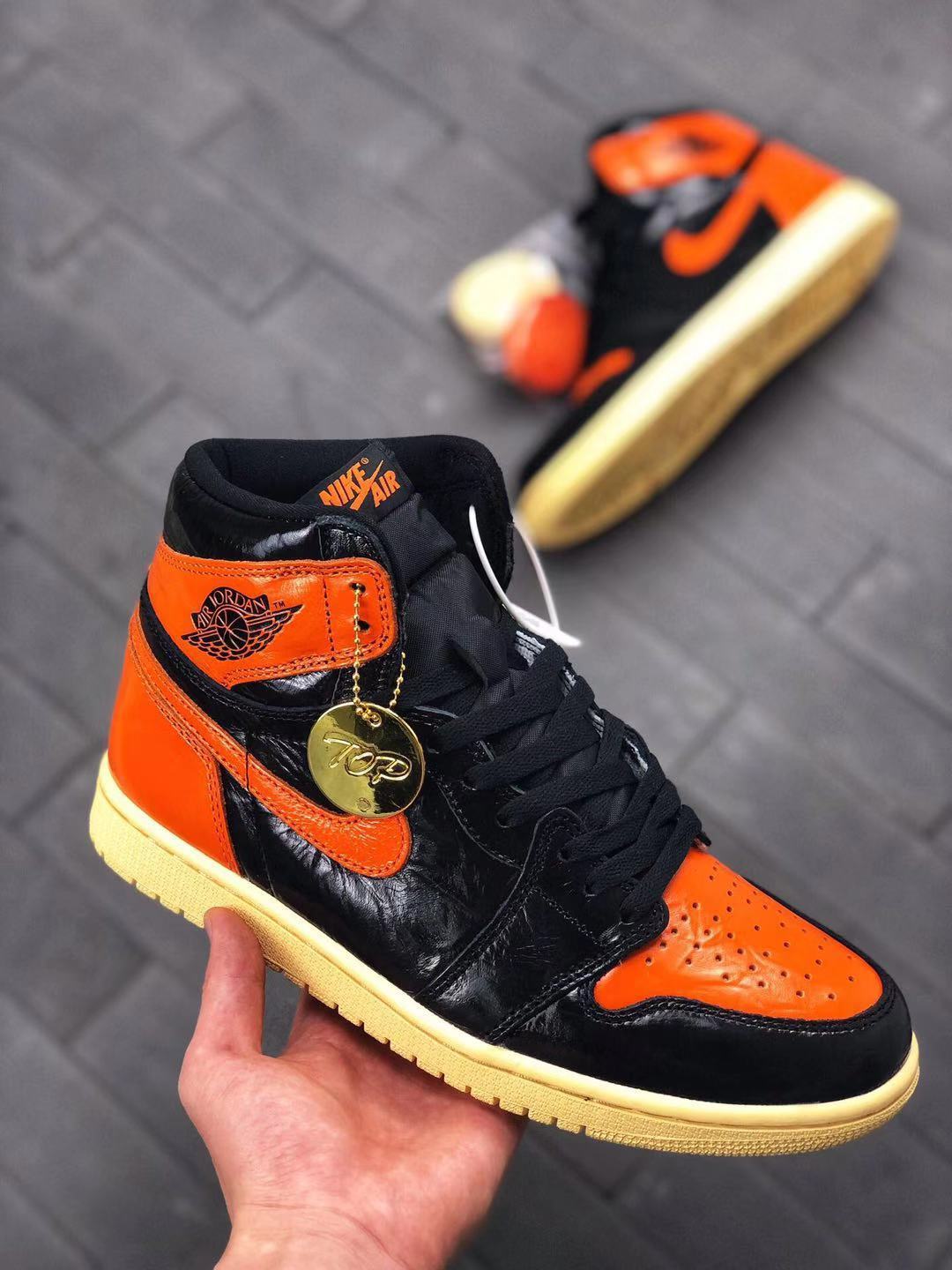 Air Jordan 1 Retro High OG Sneakers in Black and Orange - product image from the listing.