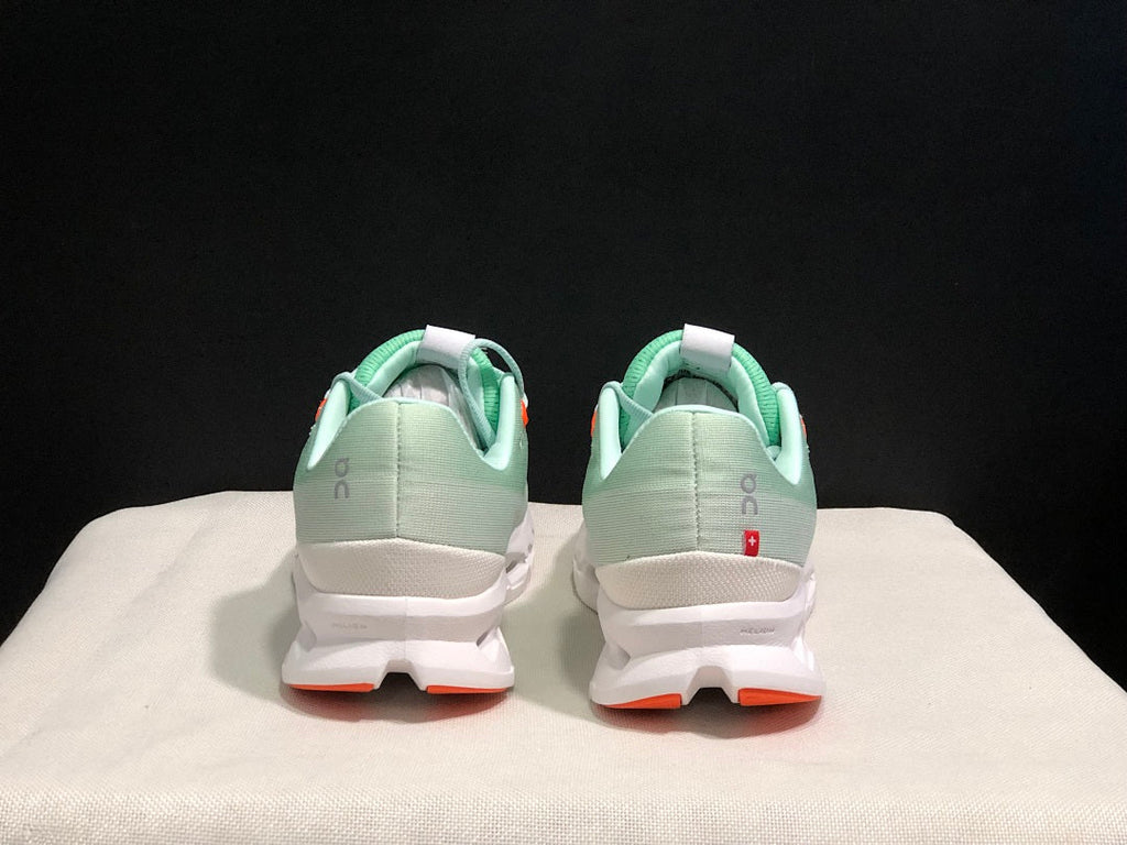 Pale Green and White On Cloudsurfer Sneakers - product image from the listing.