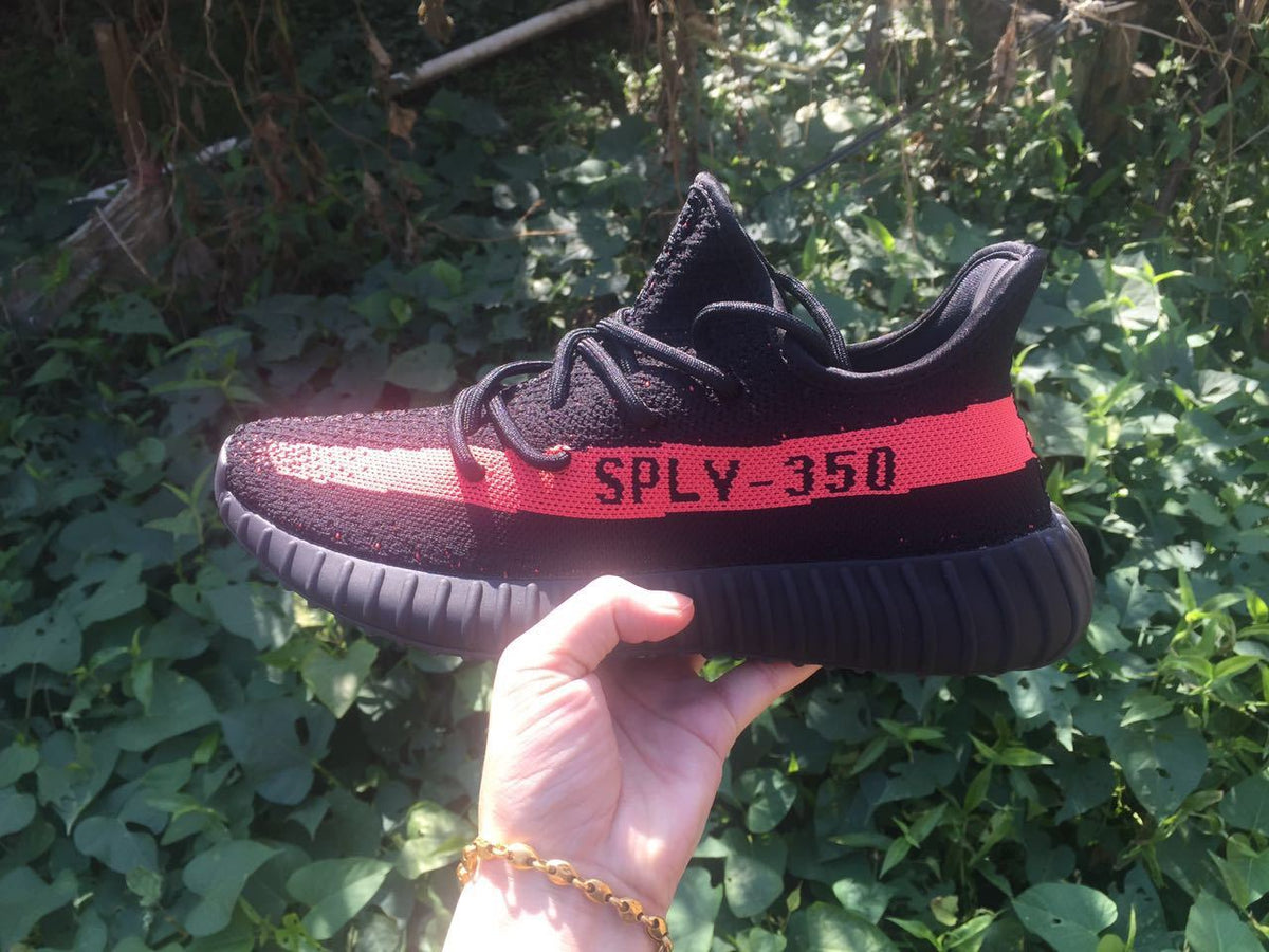 Yeezy Boost 350 V2 Sneakers in Black and Bright Coral - product image from the listing.