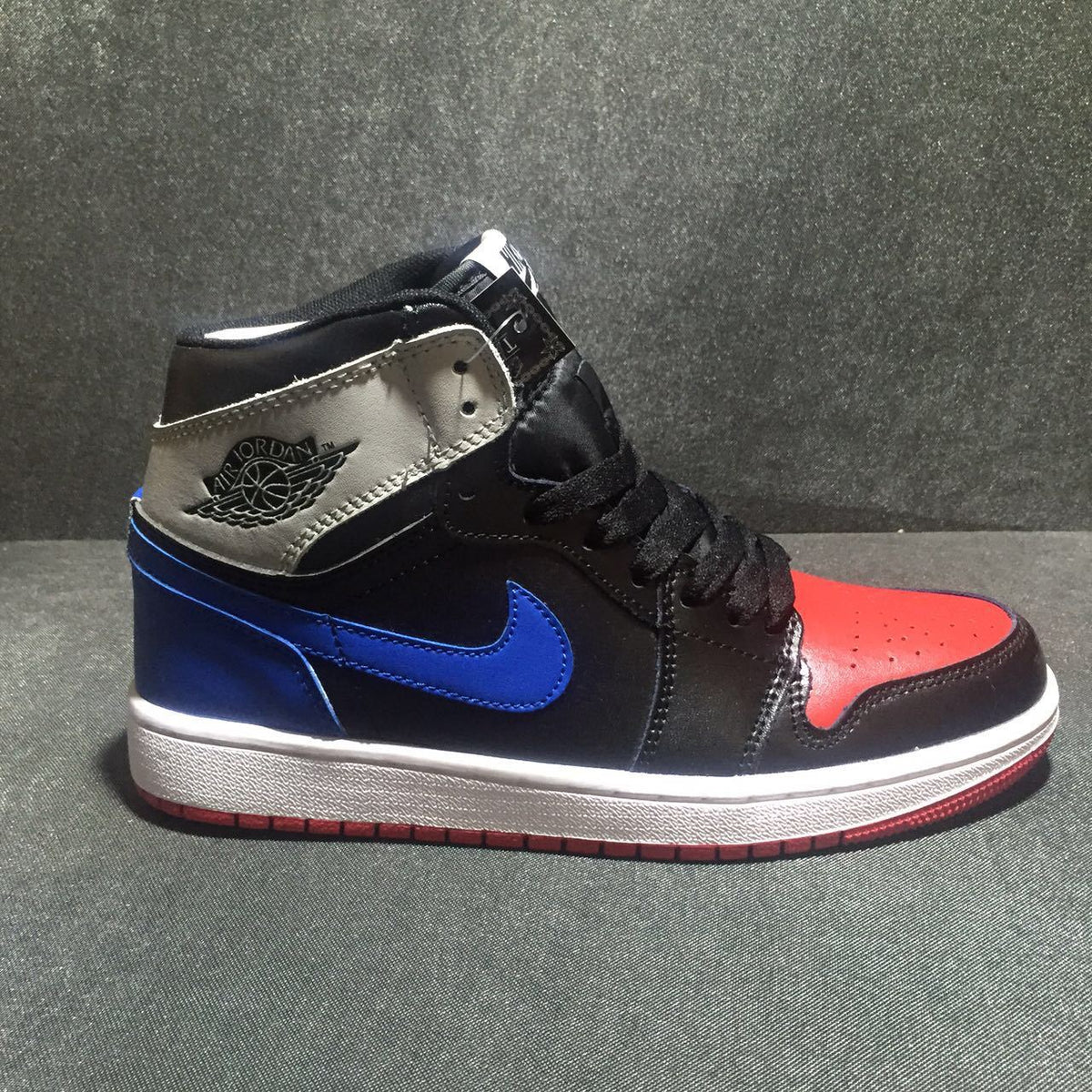 Jordan 1 High Three-Color Sneaker in Black, in Blue and Red - product image from the listing.