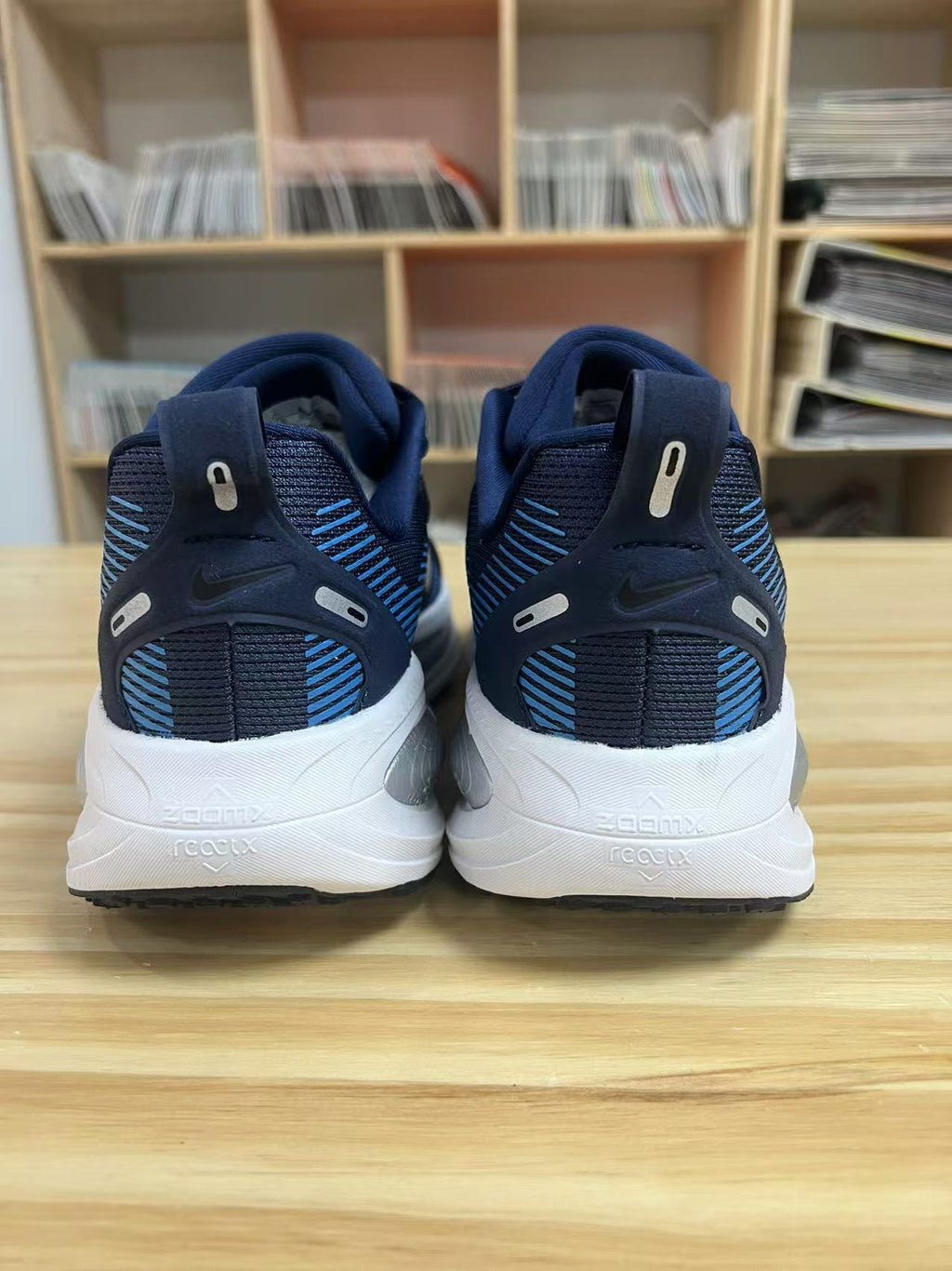 Navy and Blue Nike Vomero 18 Running Shoes - product image from the listing.
