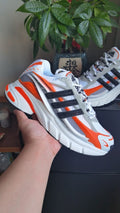 Adidas White and Orange Chunky Running-Style Trainers - product image from the listing.