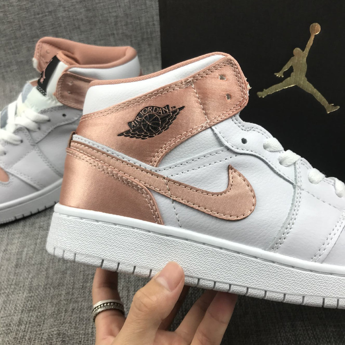 Women's Jordan 1 Mid Rose Gold Silk Sneakers 555112-190 - product image from the listing.