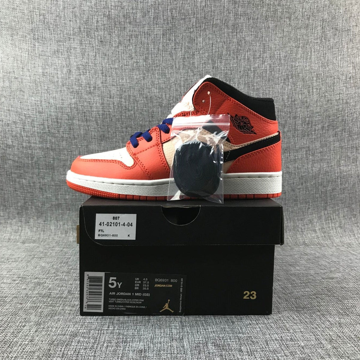 Air Jordan 1 Mid GS Sneakers in Pink and Orange - product image from the listing.